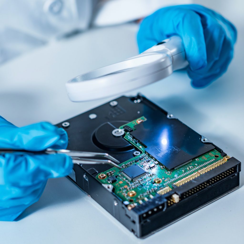 Forensic science expert examining hard drive